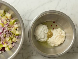 A small metal bowl containing mayonnaise, sour cream, a dollop of mustard and pickle juice.