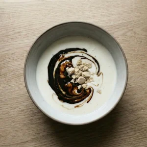 Fresh yeast crumbled into warm buttermilk with dark syrup for Finnish archipelago bread (saaristolaisleipä).