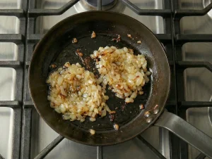 Caramelized onions cooking in a pan for Finnish cabbage casserole