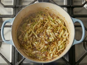 Sautéed cabbage cooking in a pot for Finnish cabbage casserole