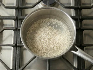 Short-grain rice cooking in water for Finnish cabbage casserole
