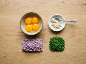 Knolling-style flat lay of Toast Pelle Janzon garnishes: egg yolks, grated horseradish, minced red onion, and chopped chives