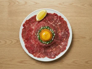 Toast Pelle Janzon assembly with minced red onion and chopped chives circling löjrom and a raw egg yolk, with a lemon wedge on the side